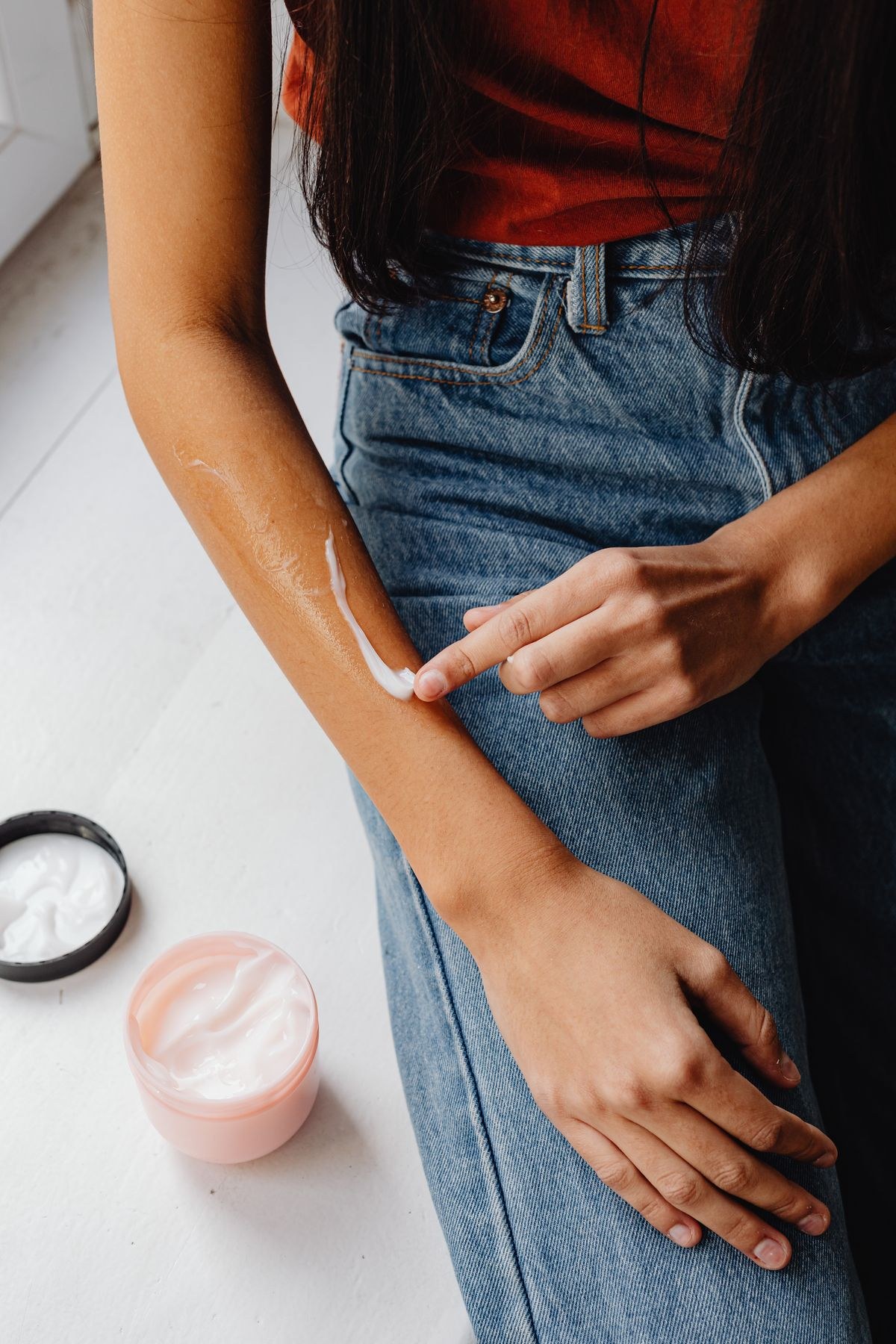 Applying a soothing moisturizing cream on itchy skin