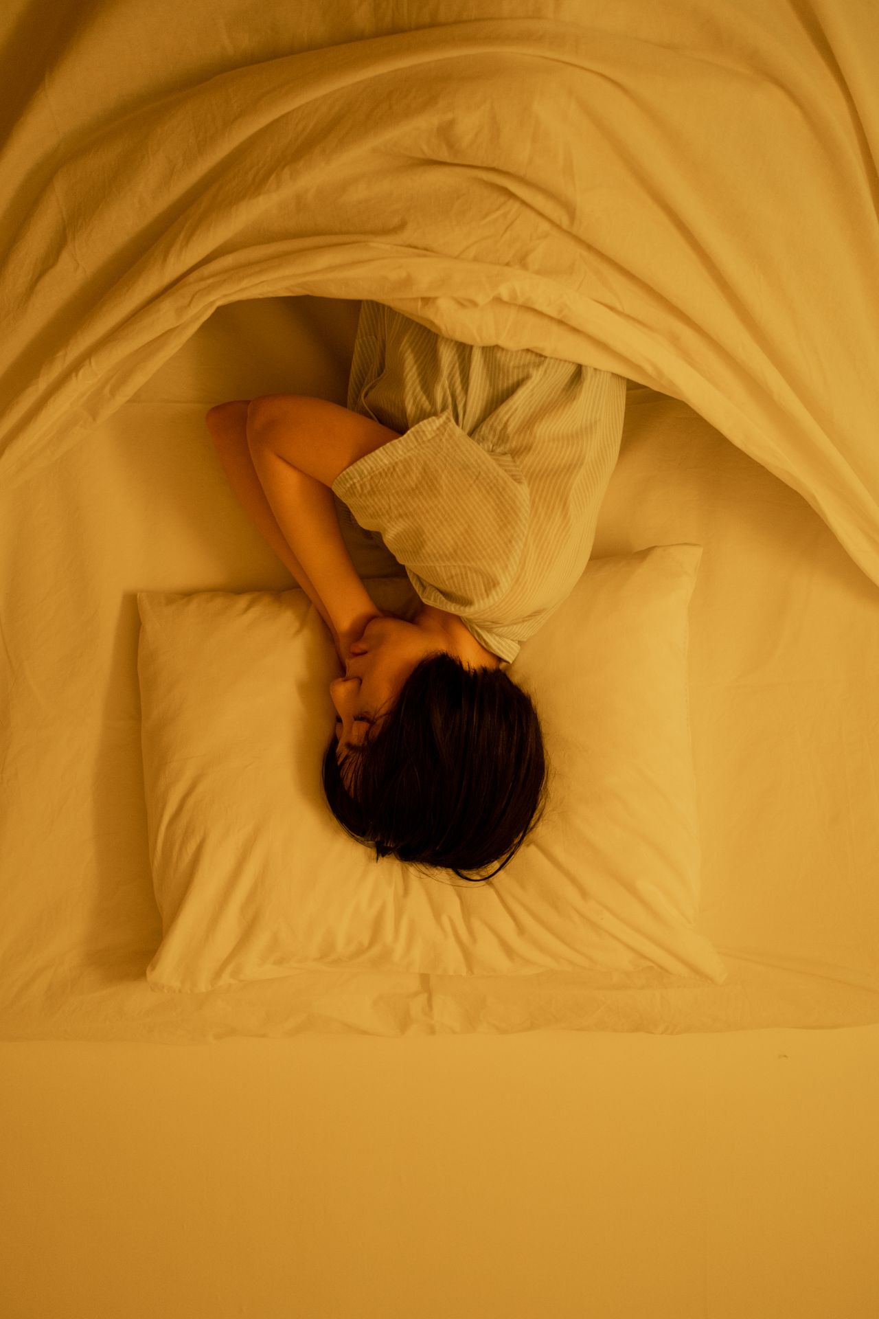 A person resting peacefully in bed while recovering from fever
