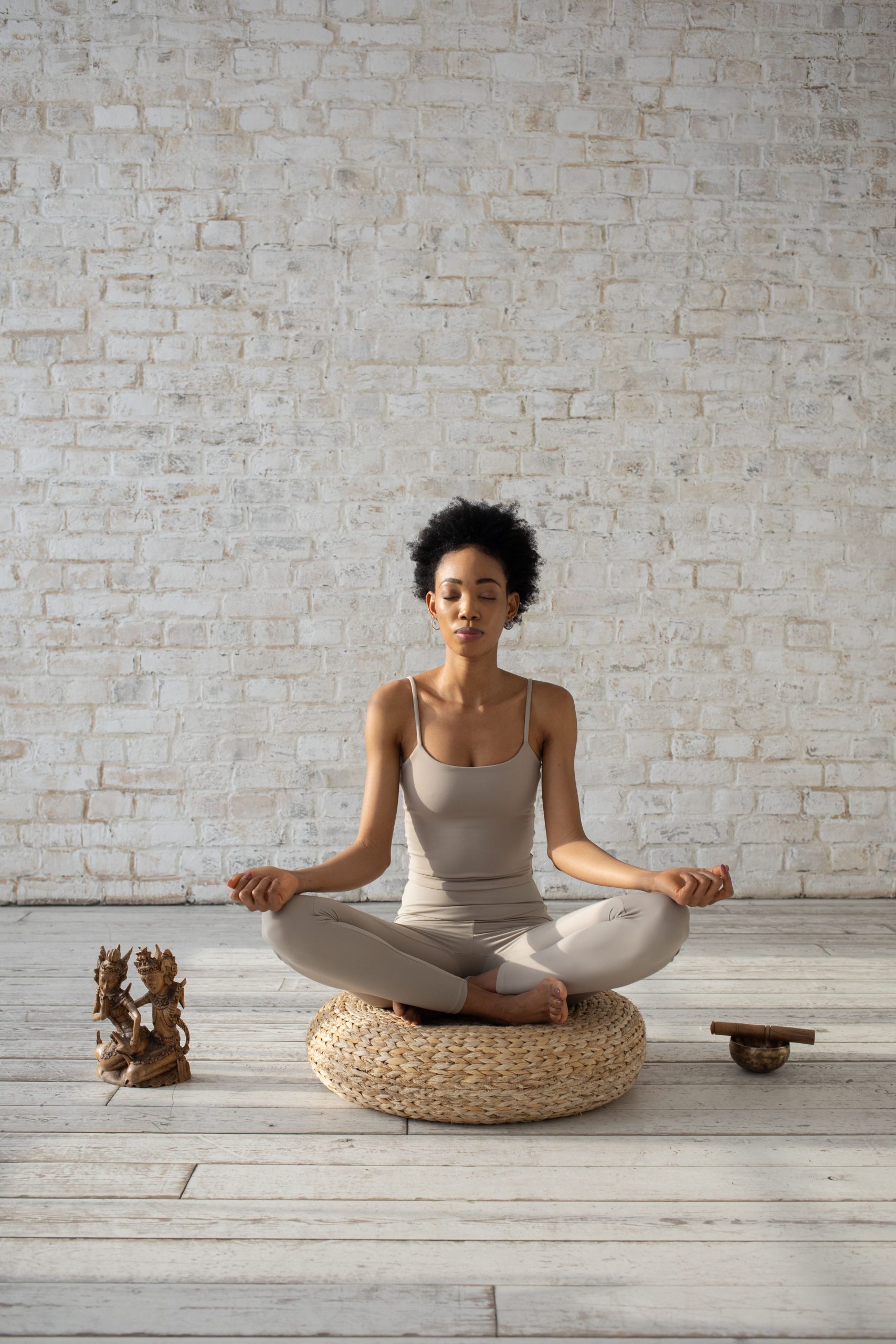 A woman meditating calmly on a cushion — slow breathing eases panic