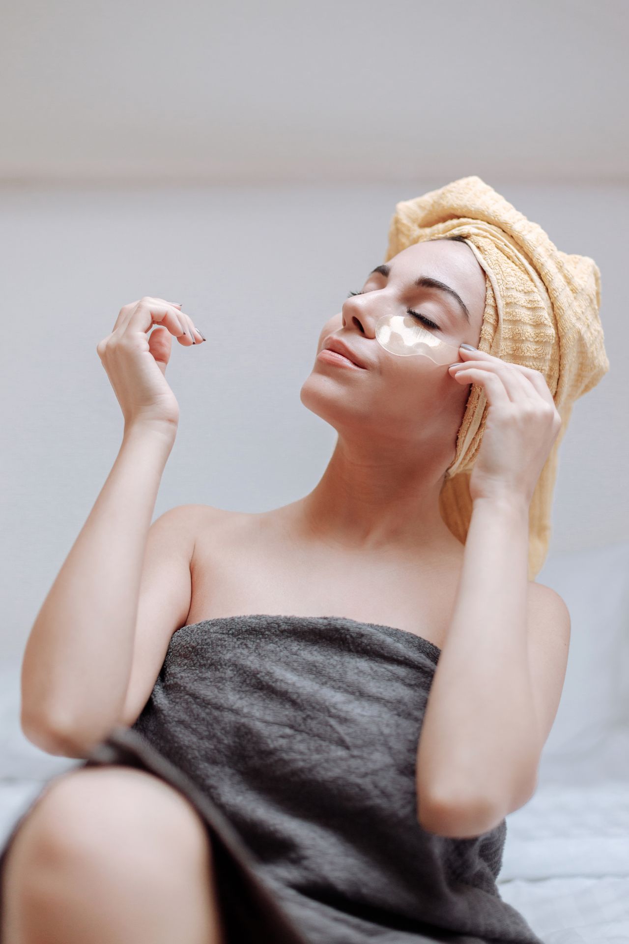 Woman applying soothing under-eye patches after eye irritation