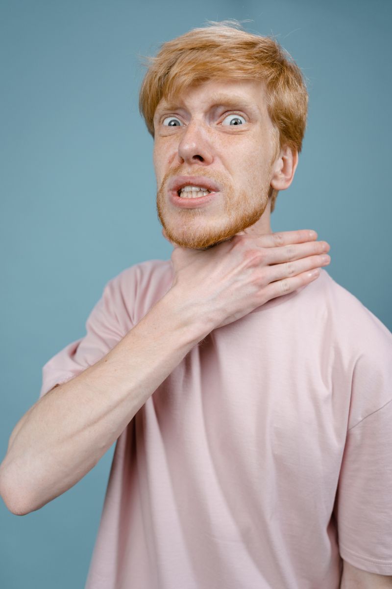 Man clutching his throat — the universal choking sign
