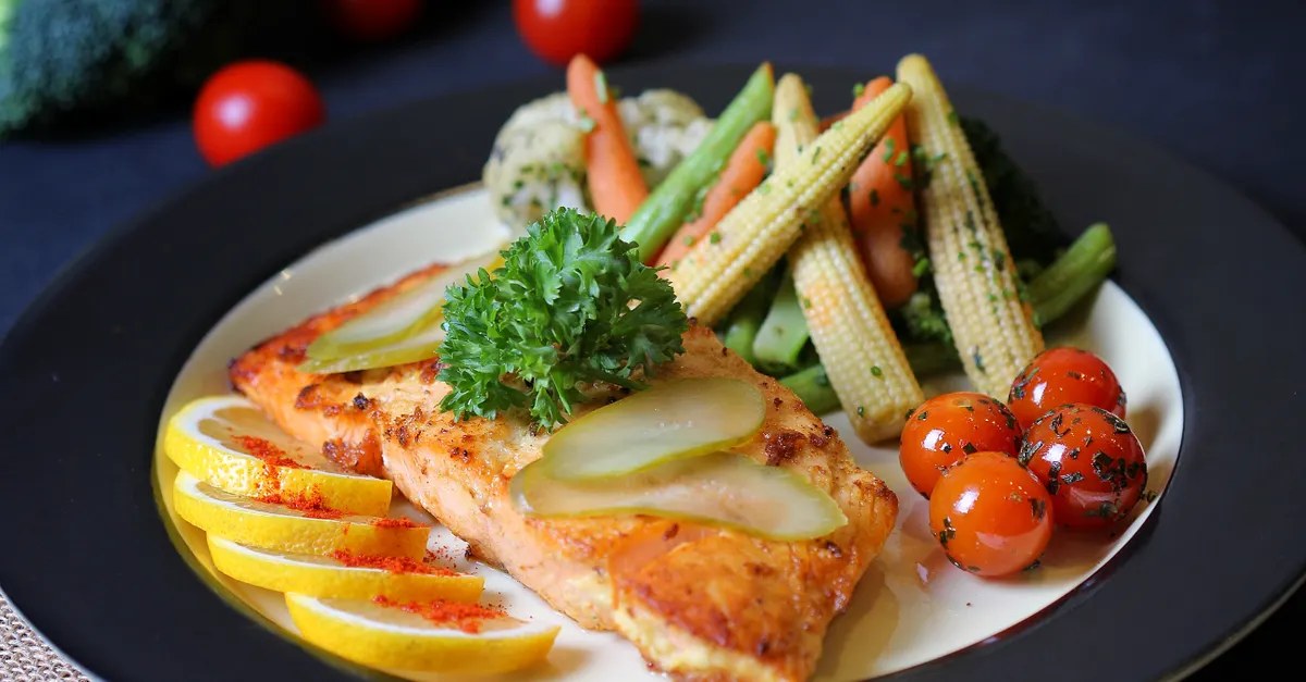 Cooked fish served on a plate at a dinner table