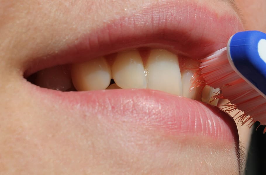 Close-up of cleaning along the gumline between teeth after food gets trapped