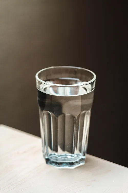 Glass of water used to rinse the mouth after biting the tongue or cheek