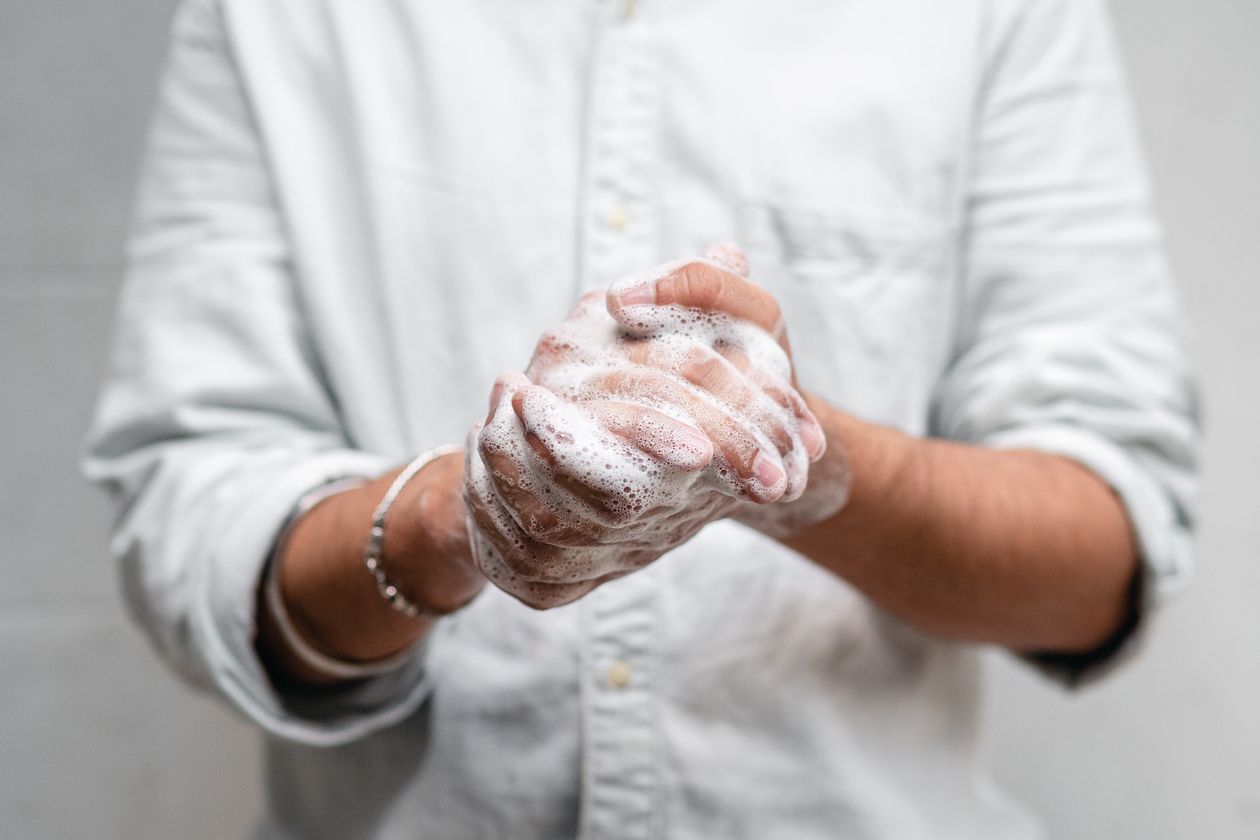 Washing soapy lather over hands — soap is an easy lubricant for sliding a stuck ring off