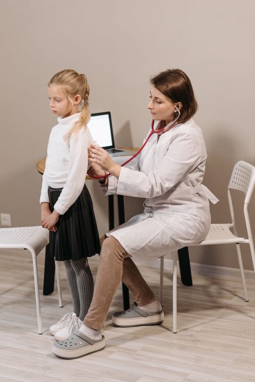 A pediatrician examining a young girl with a stethoscope. Photo: Pexels