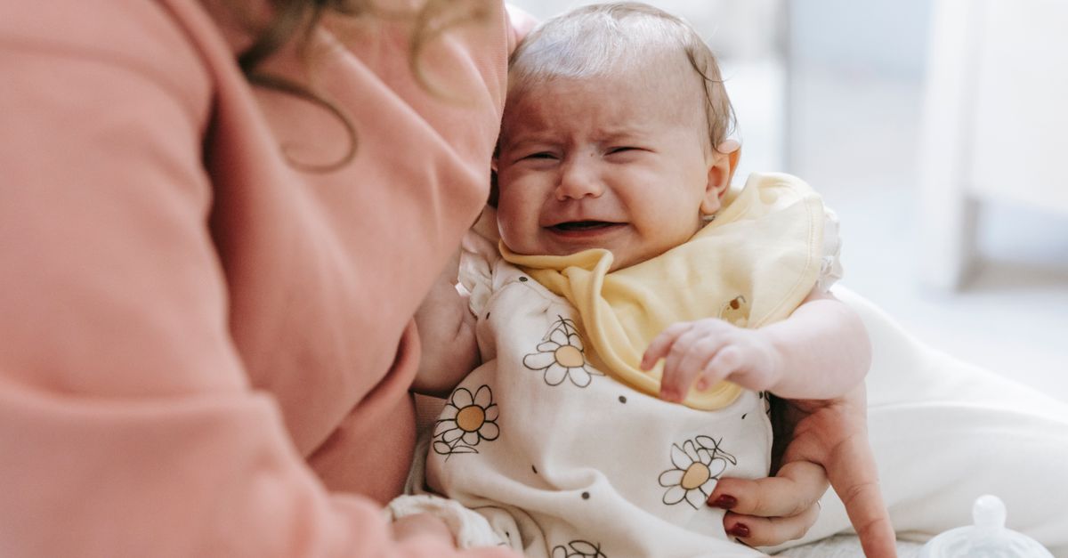 Parent comforting a distressed baby