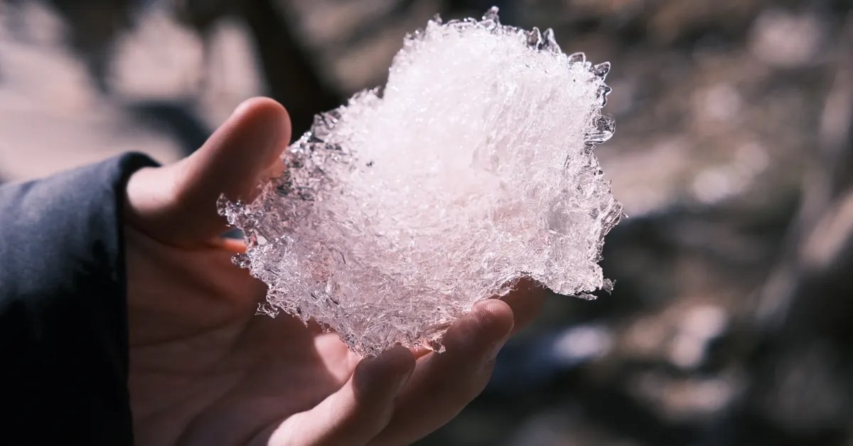 Holding a piece of ice — cold compress to reduce swelling after a dental injury